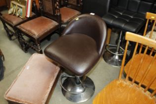 A metal framed adjustable stool