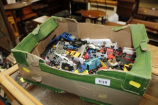 A box of various die cast toys and other