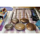 Five copper warming pans with turned wooden handle
