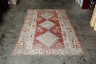 An approx. 7'10" x 4'8" patterned Kilim rug