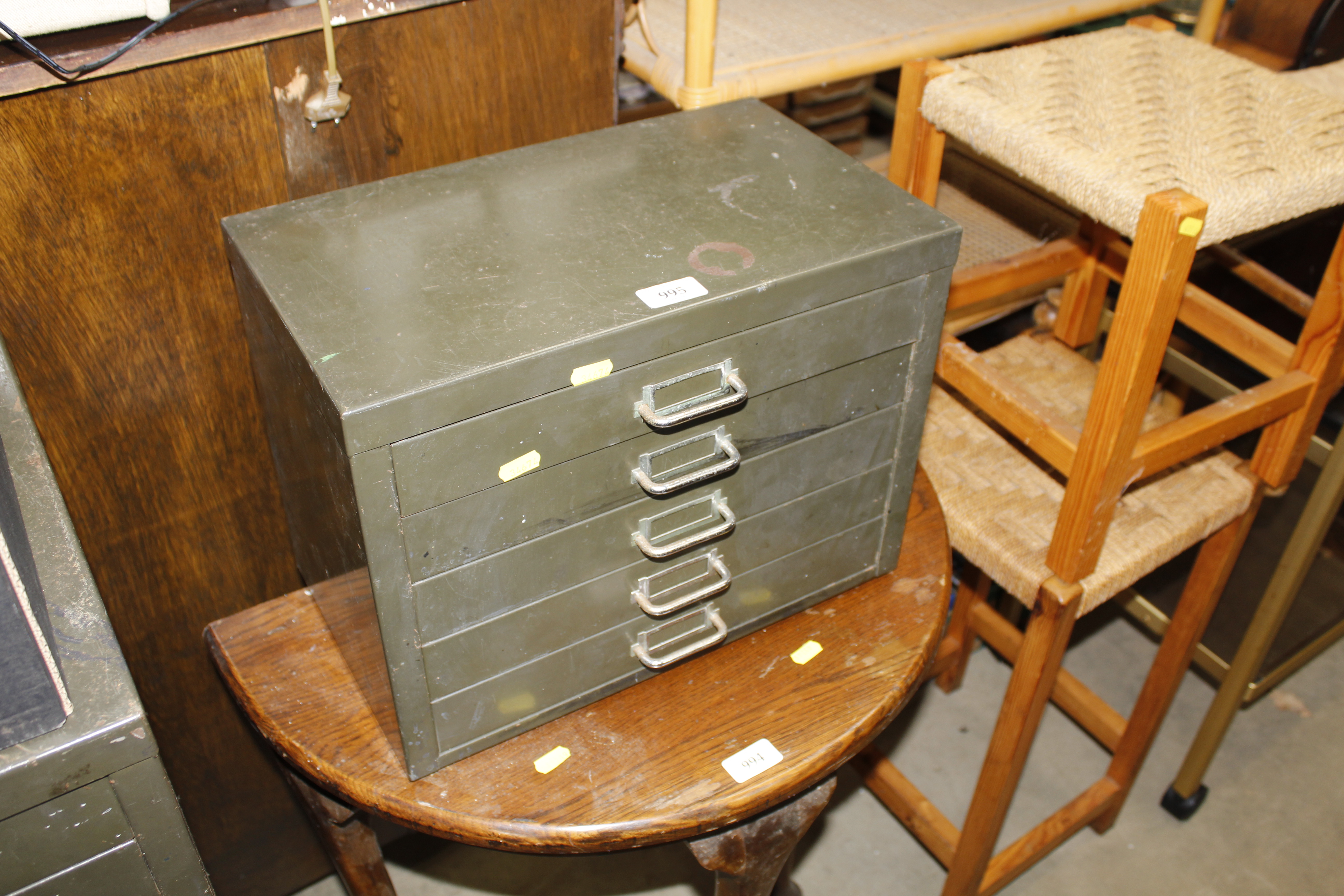 A metal table top chest fitted five drawers