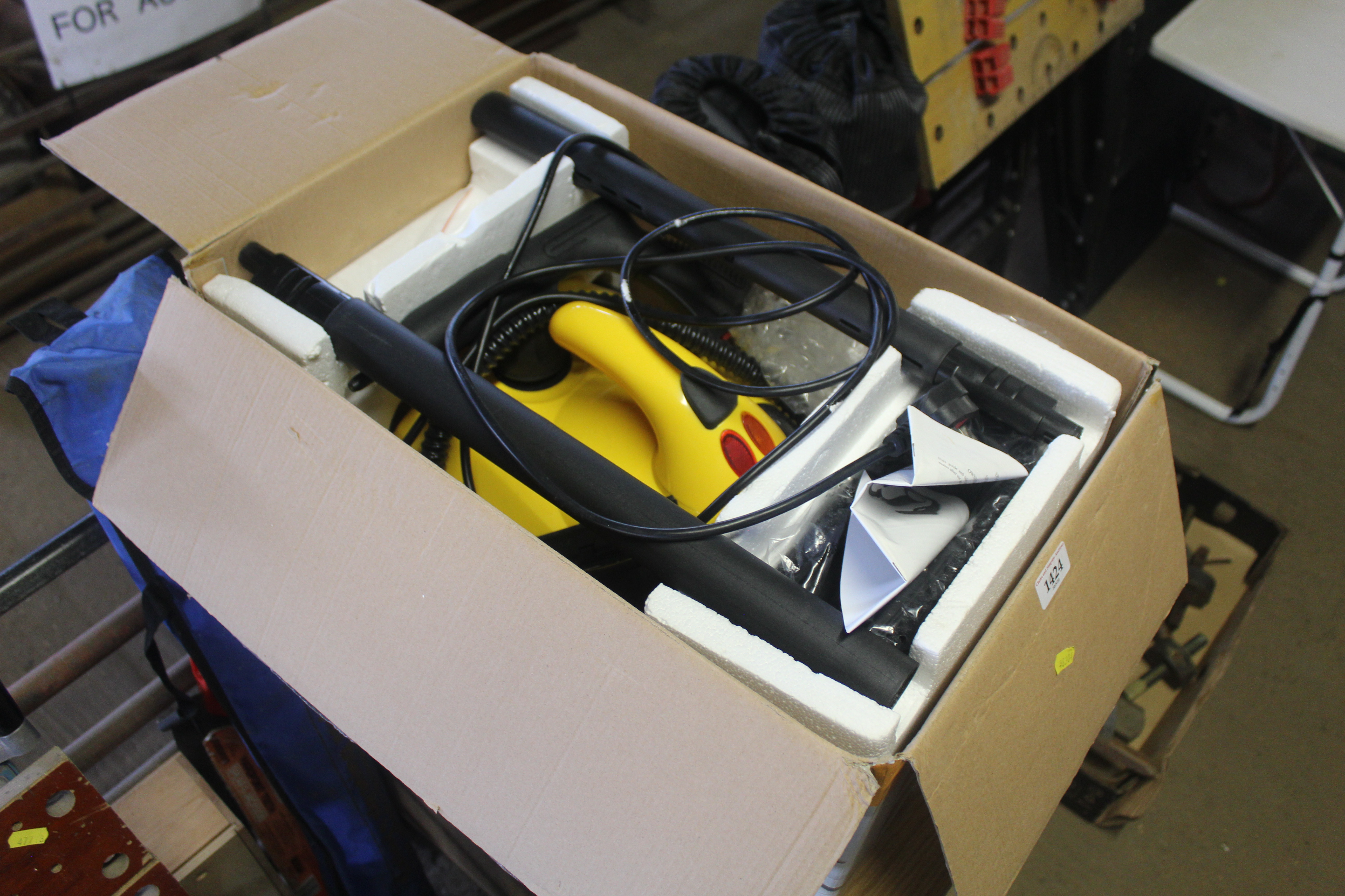 An electric steam cleaner with accessories and ori