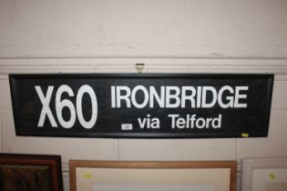 A framed and glazed X60 Ironbridge Via Telford sign