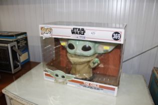 A Star Wars ' Yoda the Child' figure