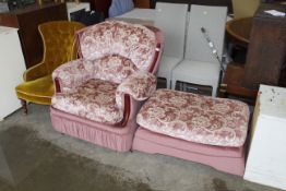 A pink upholstered armchair and matching footstool