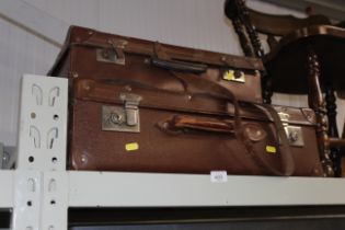 Two vintage suitcases, one containing various book