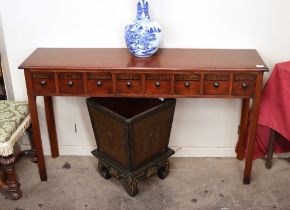 A mahogany hall table fitted eight spice labelled drawers, raised on square section tapering