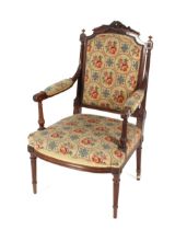 A 19th Century carved mahogany elbow chair with tapestry upholstered back panel, arm rest and