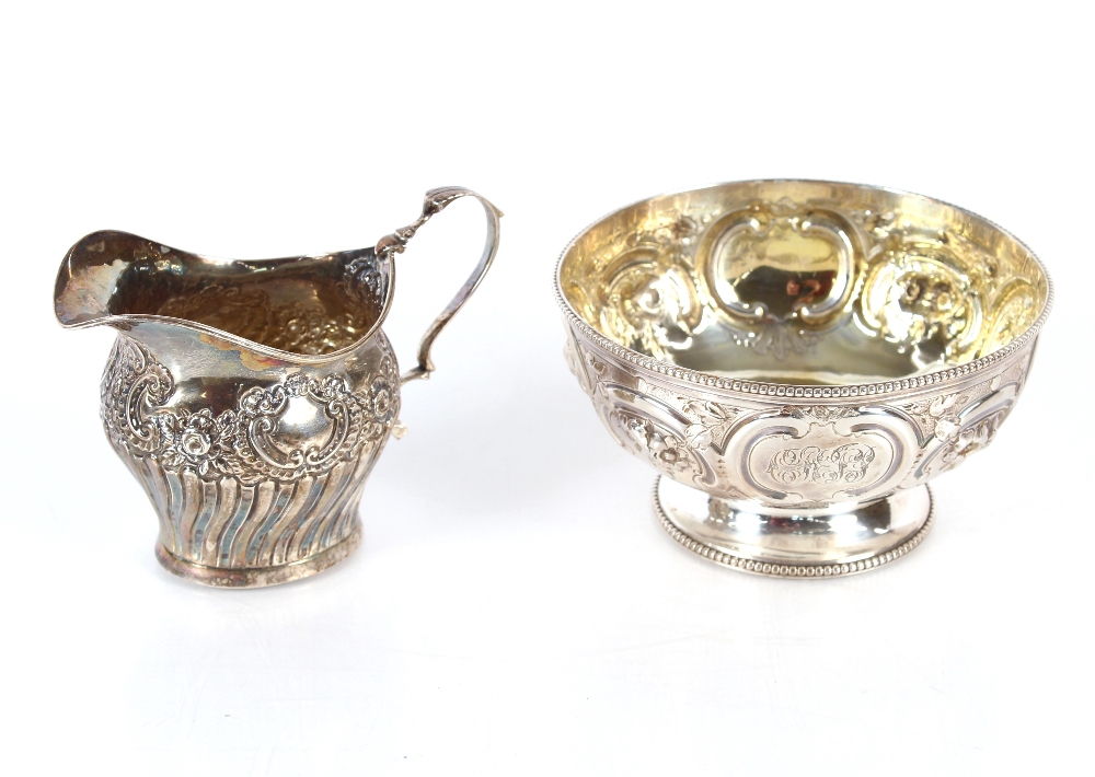 A Victorian silver sugar bowl with raised foliate decoration and monogrammed cartouche, London 1861;
