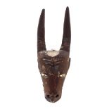 An Ethnic carved wooden goats head face mask with painted carved decoration, 58cm