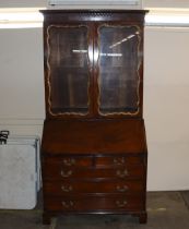 A George III style mahogany bureau bookcase, the upper glazed section enclosing shelves and drawers,