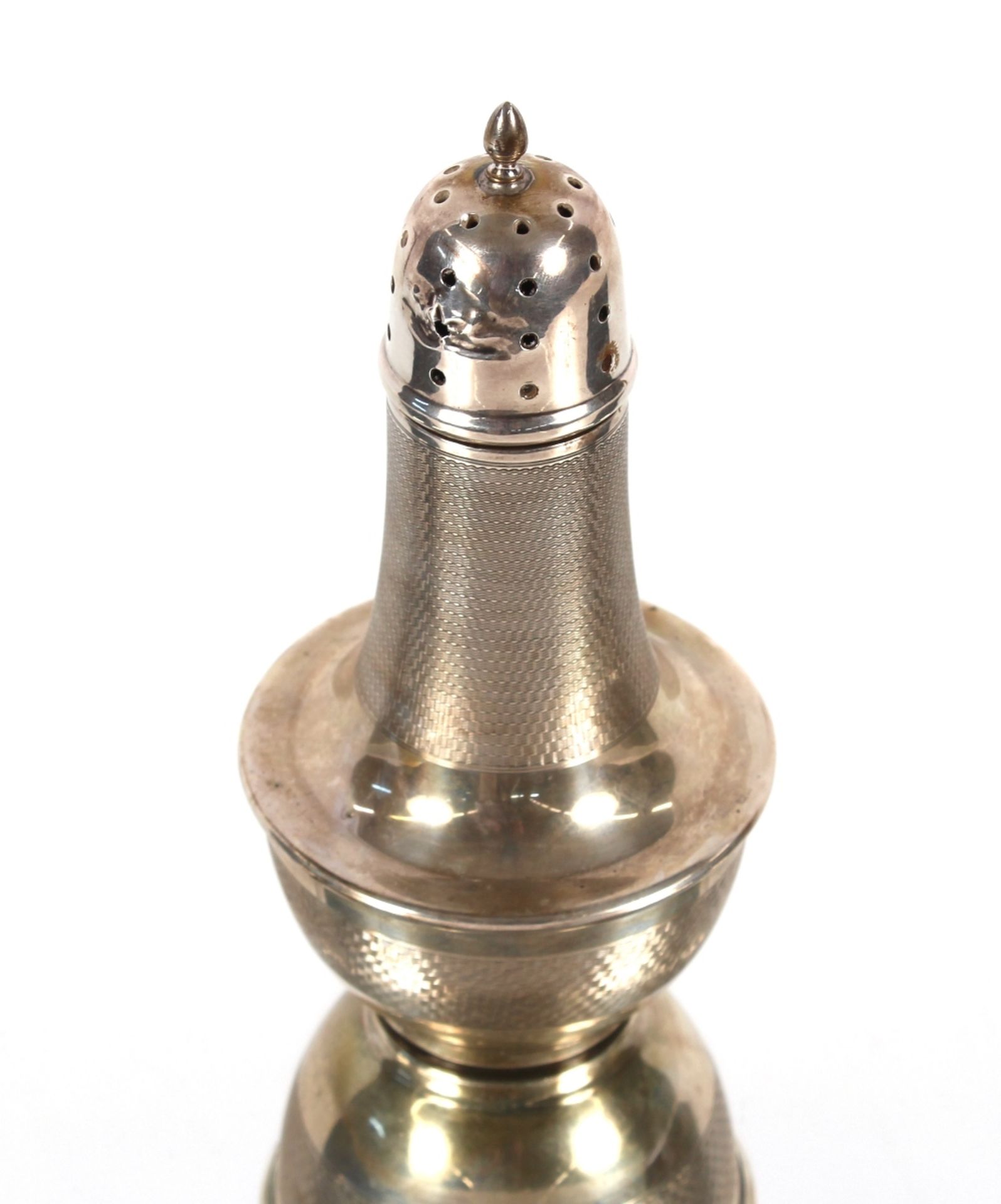 A silver baluster sugar shaker with engine turned decoration, Birmingham 1934, 16cm high