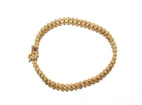 An 18ct gold and diamond set line bracelet, 8.1gms