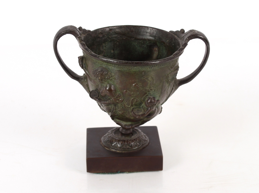 An antique bronze twin handled cup, having classical decoration of centaurs and cherubs raised on - Image 2 of 2