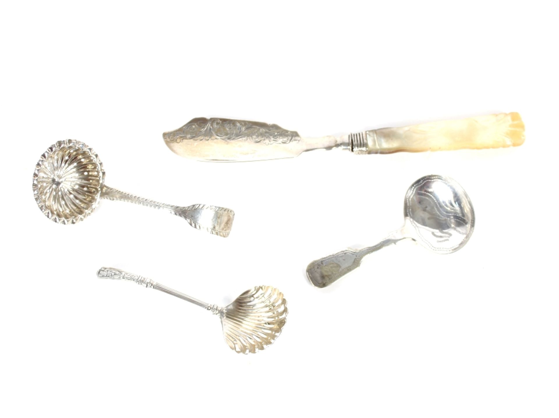 A Georgian silver sifter spoon, marks indistinct; a Victorian similar, Sheffield 1886; a plated