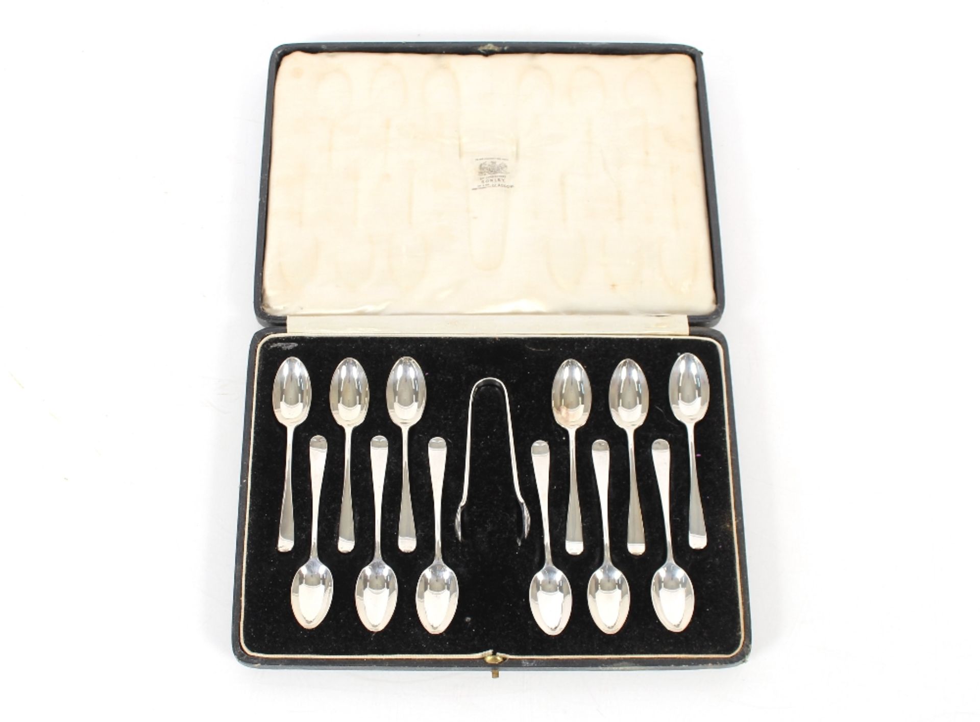 A cased set of twelve silver "Old English" pattern teaspoons and a pair of matching sugar tongs,