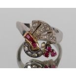 An Art Deco design diamond and ruby cluster ring, set to a white and yellow metal mount