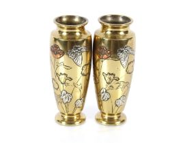 A pair of Oriental bronze baluster vases with white metal and copper inlay to the leaf decoration,