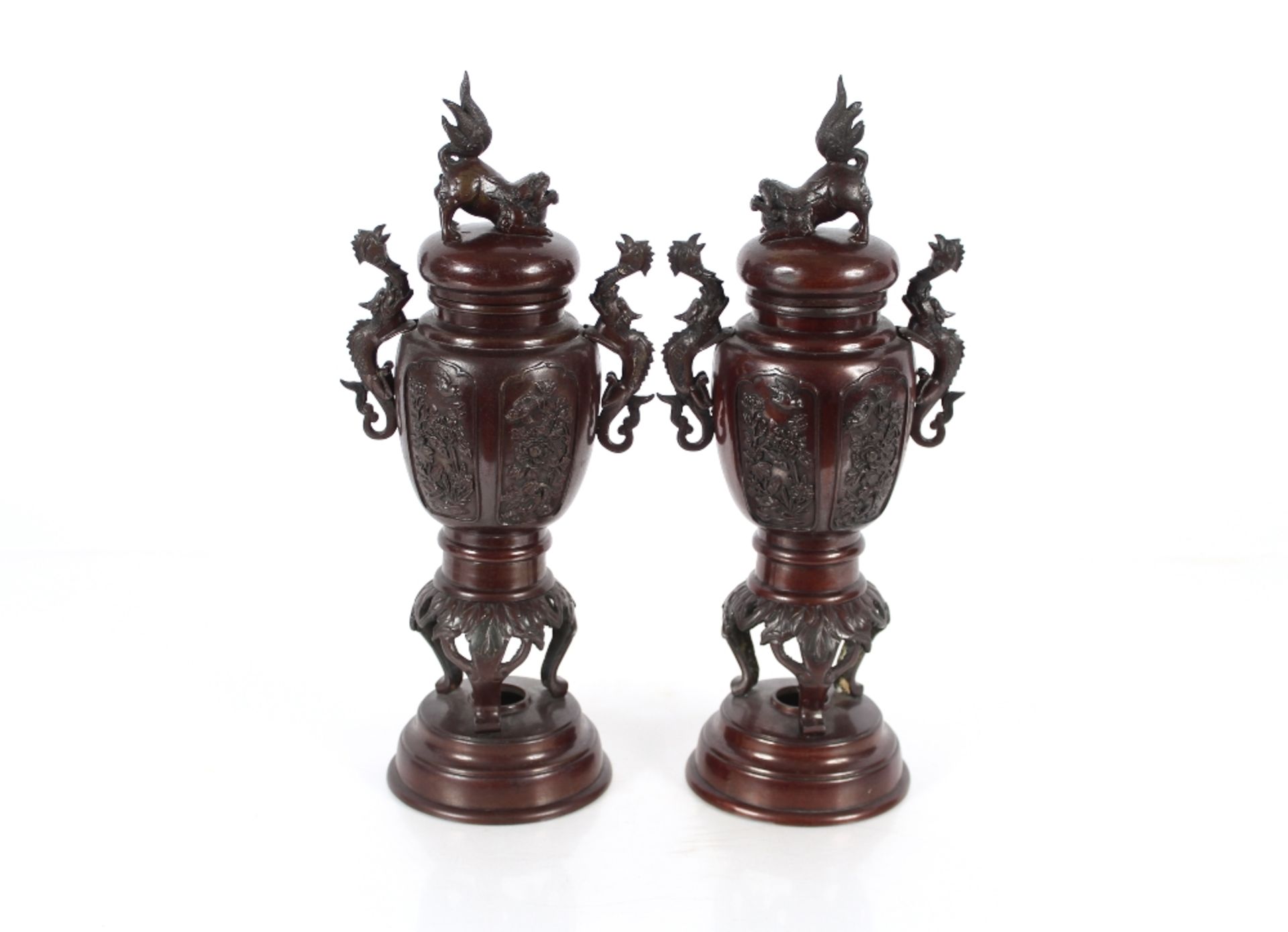 A pair of Oriental baluster bronze vases, the lids surmounted by Dogs of Fo, flanked by dragon