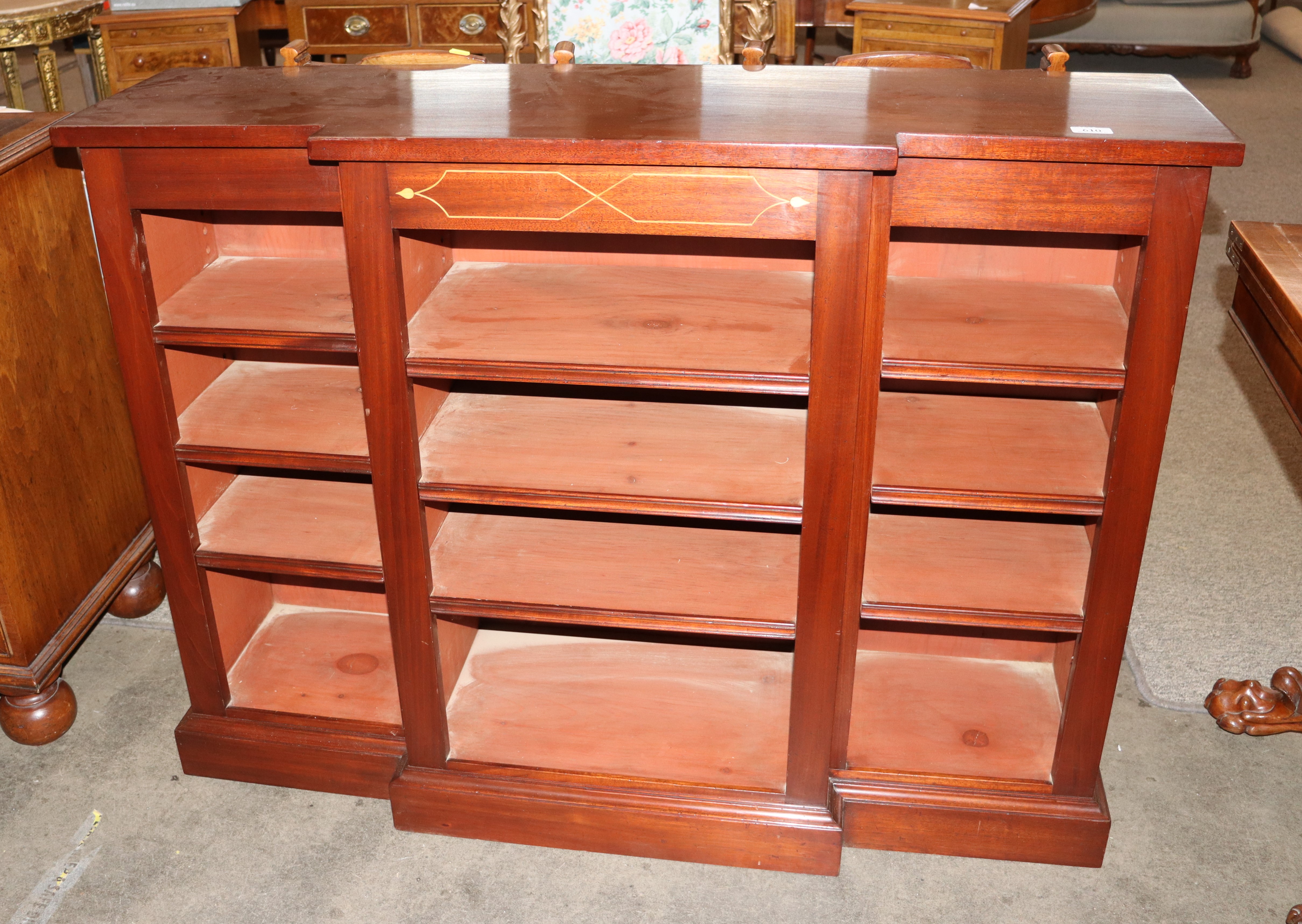 A mahogany dwarf breakfront bookcase, fitted adjustable shelves raised on a platform plinth, 122cm - Image 2 of 2