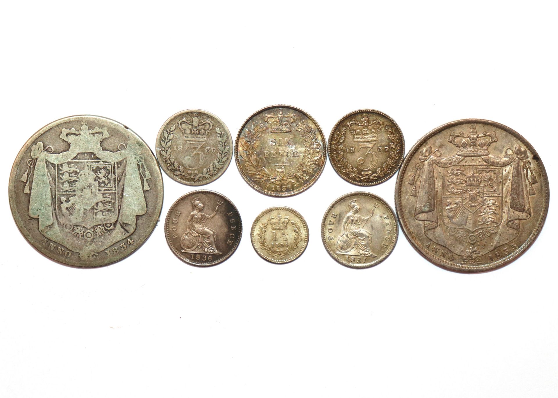 A collection of eight items of William IV silver coinage; two half crowns; a sixpence; two groats;