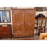 A large oak French armoire, with interior shelf and hanging compartment, two long drawers below