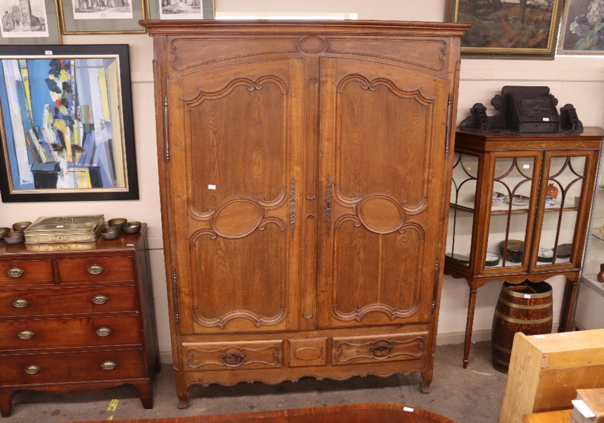 A large oak French armoire, with interior shelf and hanging compartment, two long drawers below