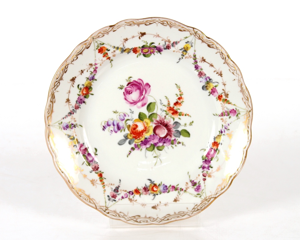 A Meissen part tea set, having painted foliate sprays heightened in gilt within shaped borders,