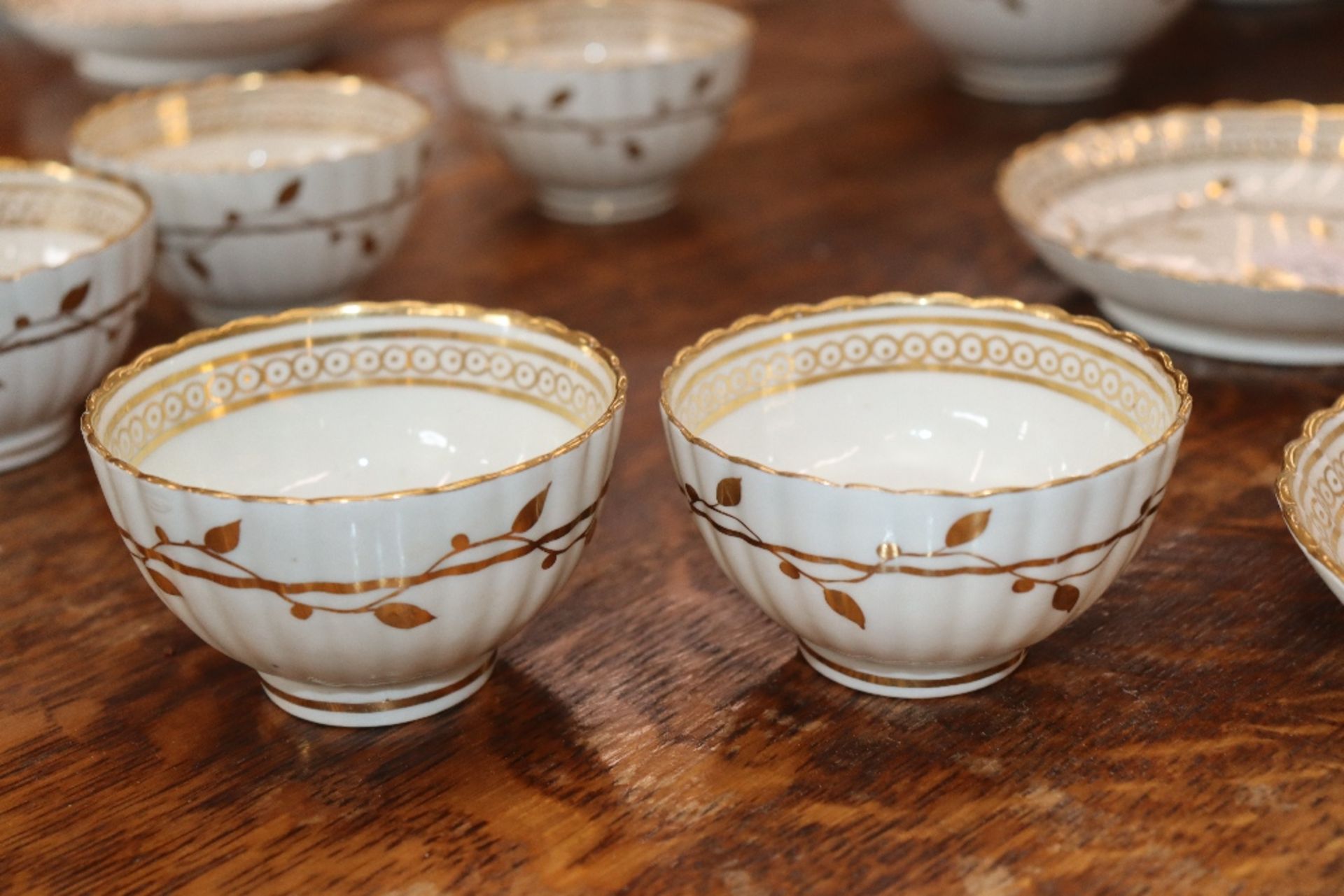 An early 19th Century English porcelain part tea set, of fluted design comprising numerous cups, - Image 20 of 32