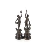 A pair of French spelter figures, raised on circular wooden plinths, 33cm high