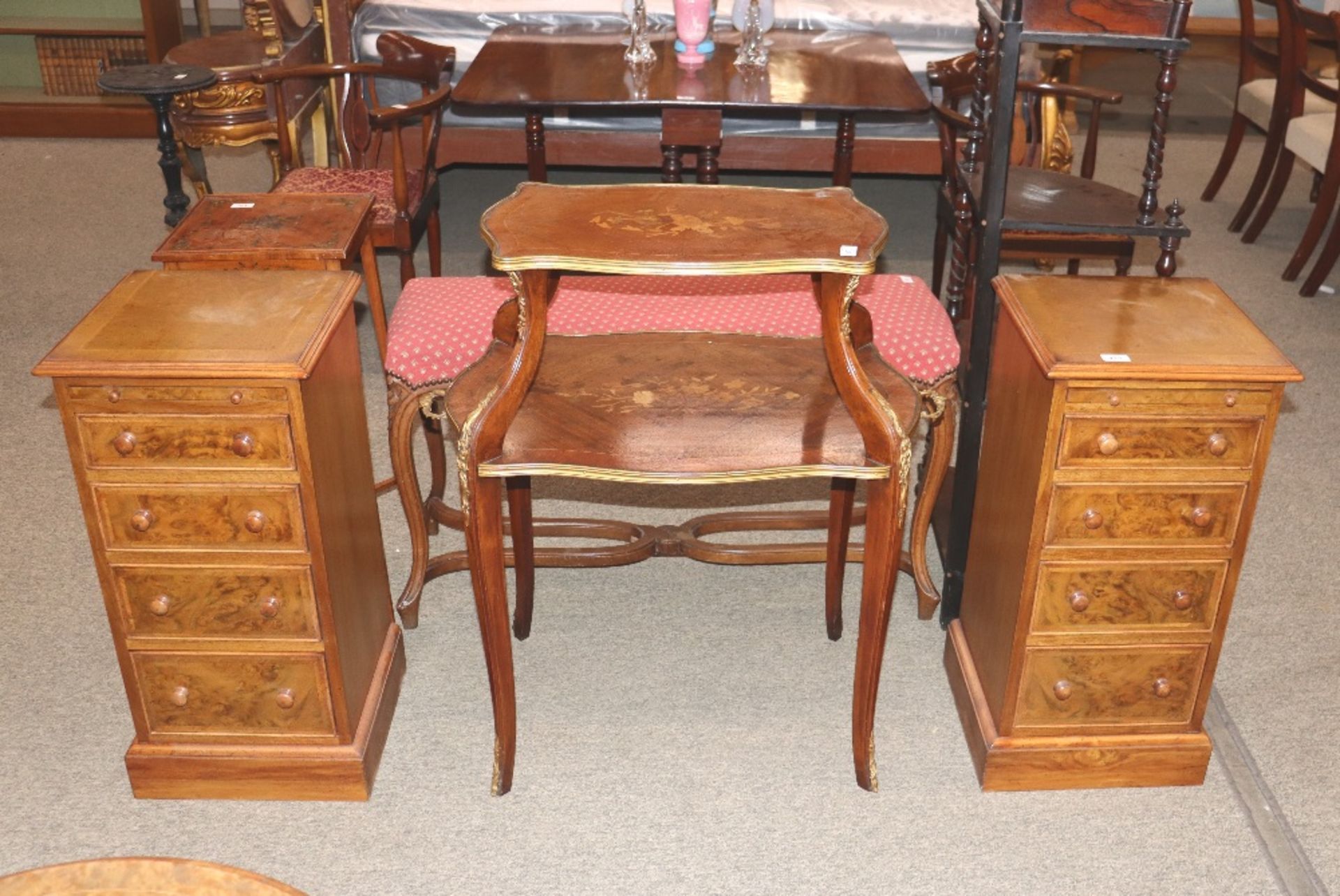 A pair of walnut and chequer banded bedside chests, fitted brushing slides and four drawers,