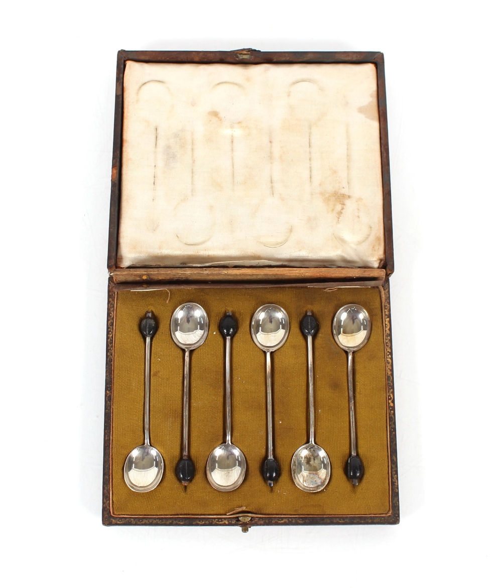 A cased set of six silver bean topped coffee spoons