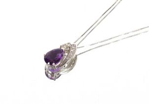 A 9ct white gold diamond and amethyst set necklace, hung to a fine link chain