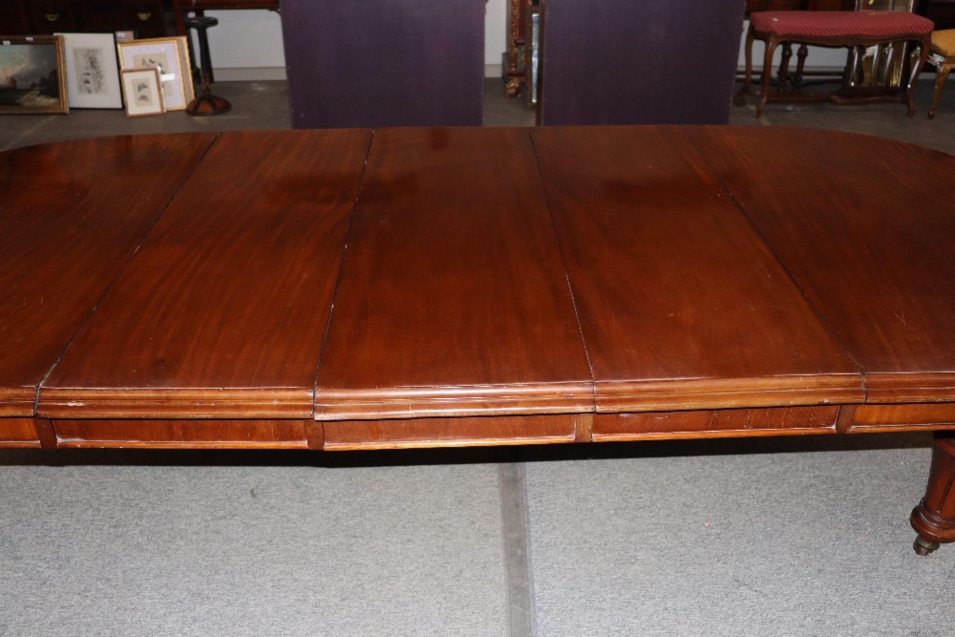 A large Victorian mahogany extending dining table with three extra leaves, raised on leaf carved and - Image 5 of 7