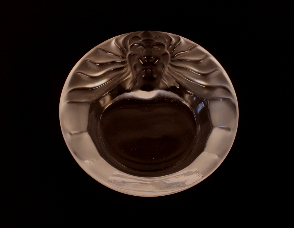 A Lalique lion decorated ash tray and a scent bottle