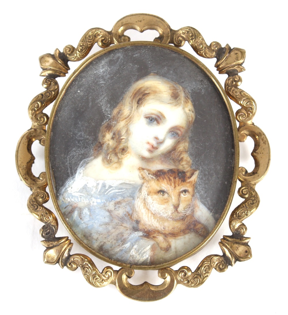 A miniature painting depicting a young girl holding a cat, contained in yellow metal scrolled frame,