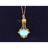 An Art Nouveau 14ct gold and turquoise set pendant hung to a fine link chain, 3gms