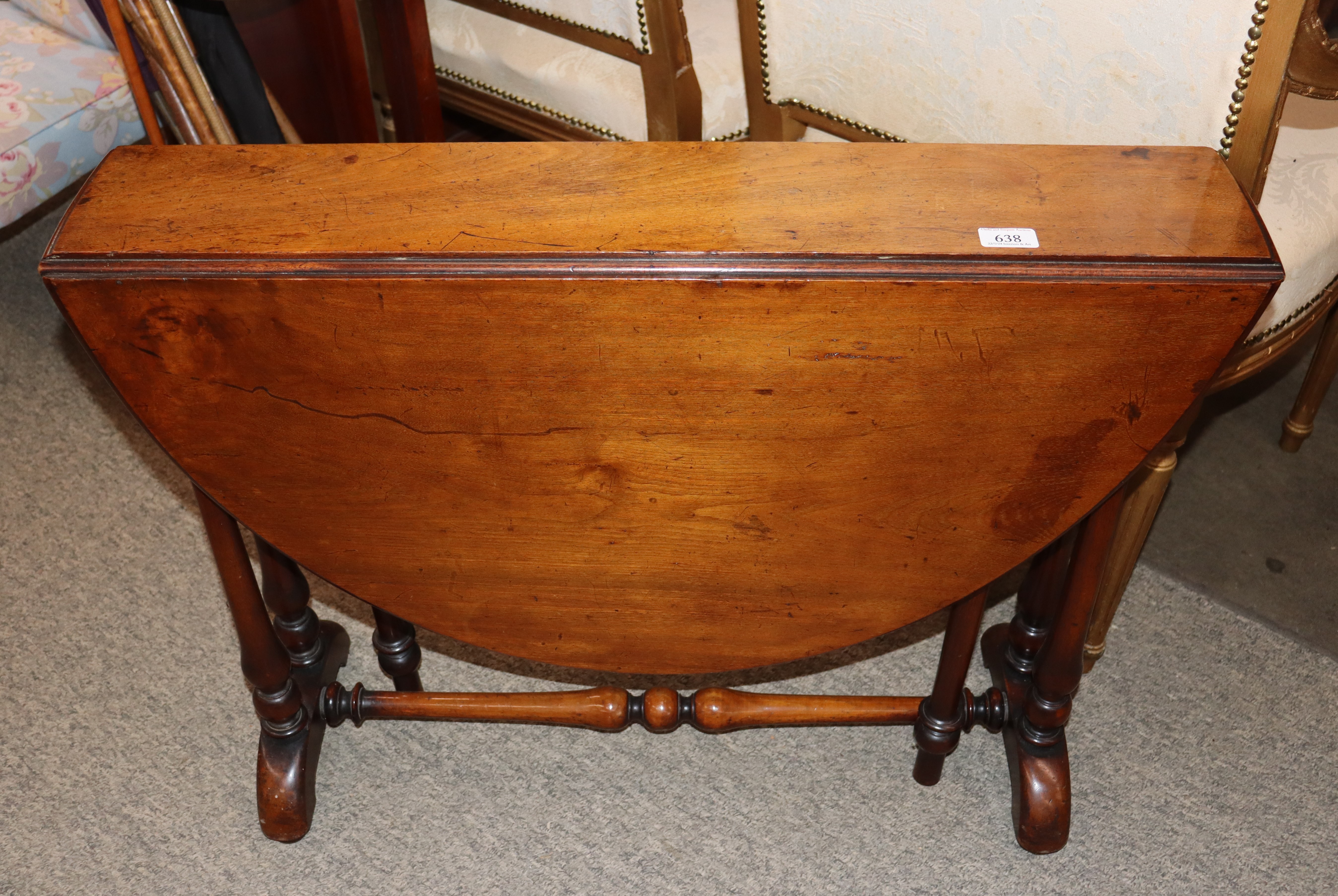 A Victorian walnut Sutherland tea table, the rounded drop leaves raised on turned columns and shaped