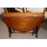 A Victorian walnut Sutherland tea table, the rounded drop leaves raised on turned columns and shaped