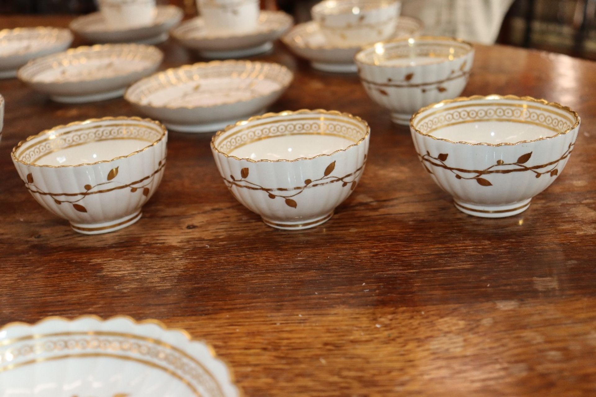 An early 19th Century English porcelain part tea set, of fluted design comprising numerous cups, - Image 11 of 32