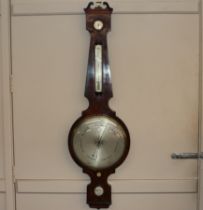 A 19th Century figured mahogany wheel barometer by West, Charing Cross, London, having large