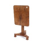 A 19th Century mahogany tilt top occasional table, raised on octagonal column and triform base