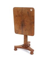 A 19th Century mahogany tilt top occasional table, raised on octagonal column and triform base