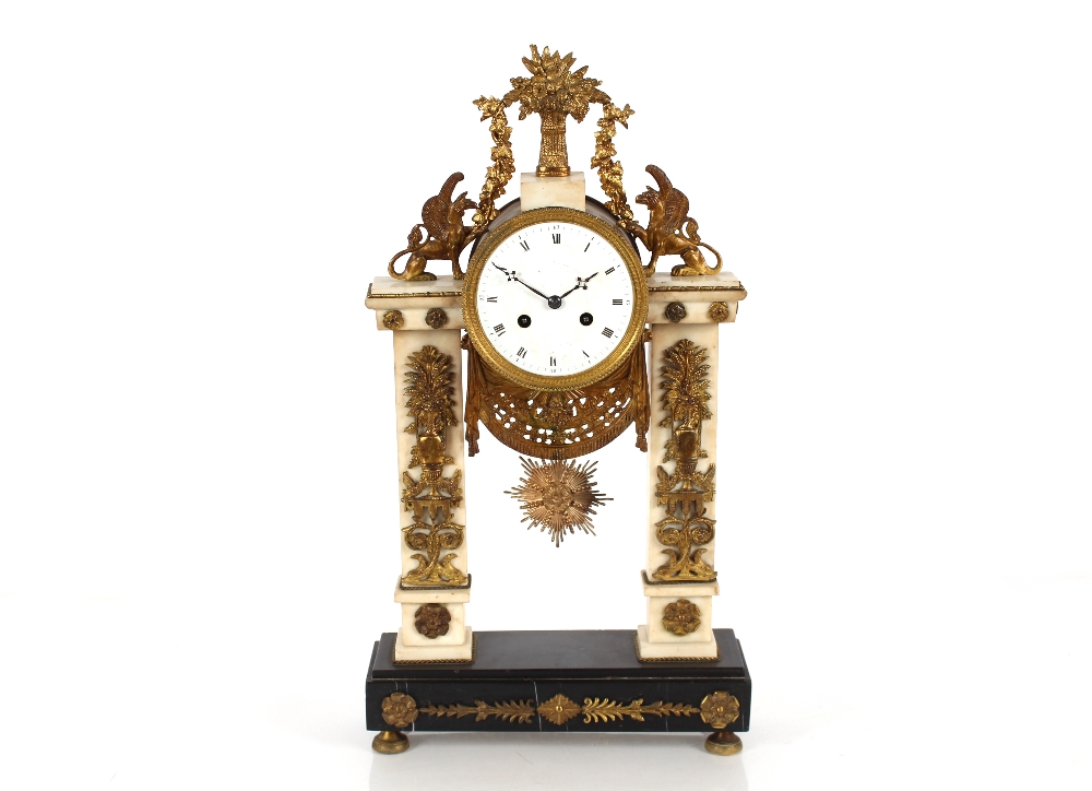 A 19th Century French marble and Ormolu mounted mantel clock surmounted by griffins and garlands