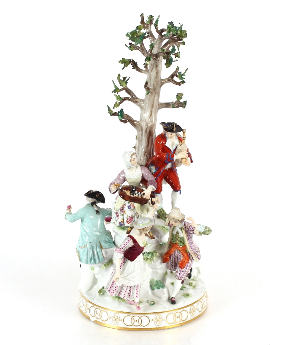 A large 19th Century Meissen figure group depicting villagers dancing and drinking before a floral