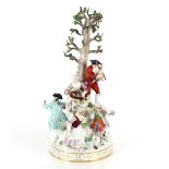 A large 19th Century Meissen figure group depicting villagers dancing and drinking before a floral