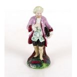 Continental porcelain figure group of a gentleman in breeches reclining against a tree stump;