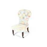 A Victorian walnut framed nursing chair, having shaped buttoned back and bow fronted seat, raised on