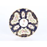 A Royal Worcester cabinet plate, profusely decorated butterflies and birds on a blue scale ground