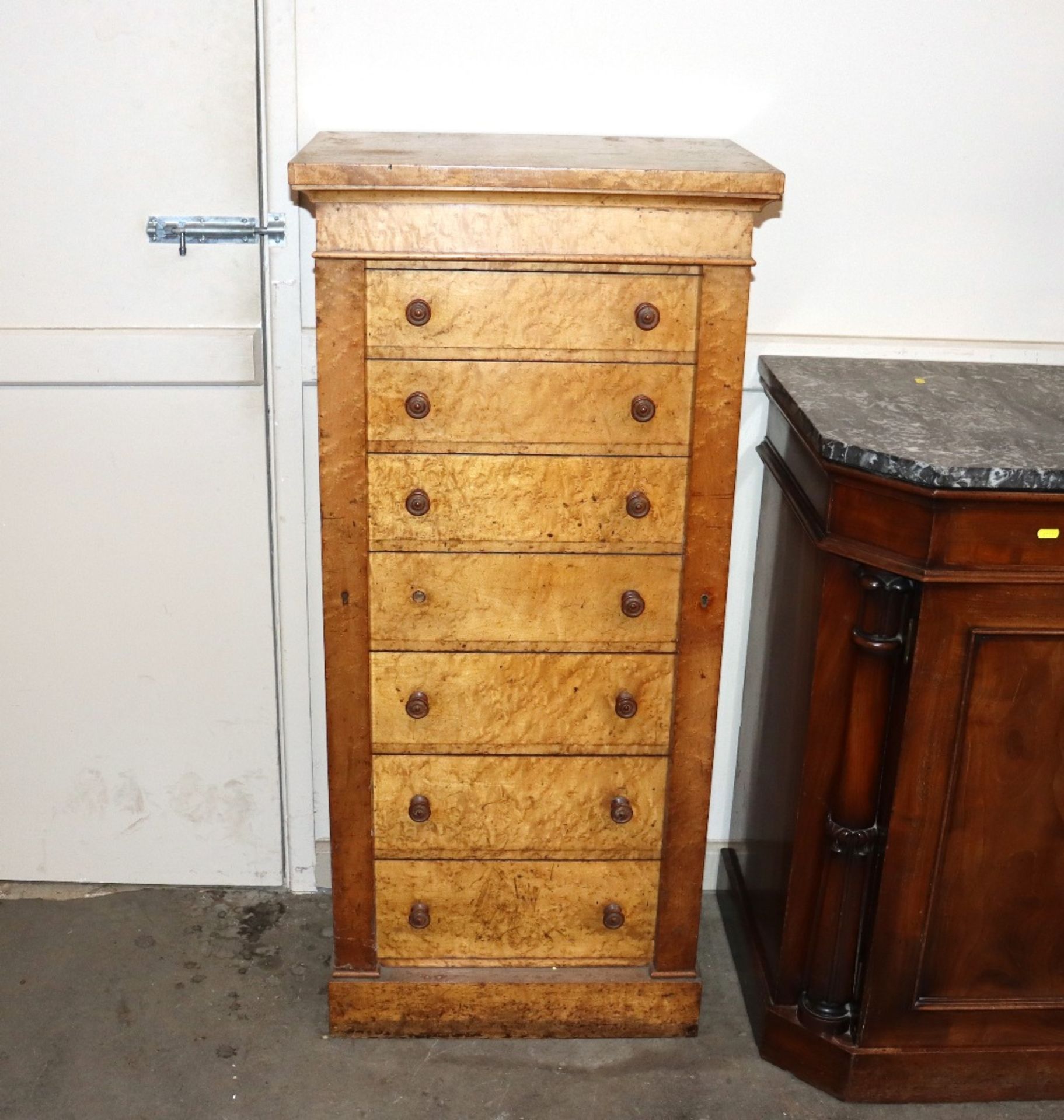 A Victorian walnut Wellington chest fitted seven drawers within locking pillar, raised on platform